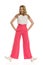 Woman In Pink Wide Legs Trousers Is Standing Legs Apart, Holding Hands In Pockets And Smiling