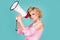 Woman pinup screaming in megaphone isolated on background studio portrait. Shout girl speaks in a loudspeaker megaphone.