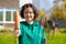 Woman with pitchfork and carrot at her garden