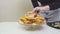 woman place cheeseburgers and french fries on a round glass dish. original cake