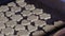 A woman places cookies from rolled dough on a baking sheet. Close-up shot