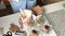 A woman places layers of biscuit crumbs and cream in bowls. Prepares a dessert with cream and biscuit crumbs