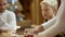 Woman places pie on a dish on Christmas table