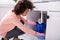 Woman Placing Bucket Under The Sink Pipe