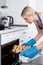 Woman Placing Cookies In Oven