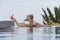 Woman Placing Daiquiri On Poolside