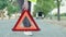 woman placing the emergency triangle on the road