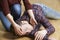 Woman Placing Man In Recovery Position After Accident