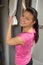 Woman placing towel on open locker door