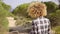 Woman in Plaid Shirt Walking on Sand near Coast