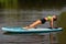 Woman planking backwards on SUP at water