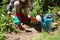 Woman planting sapling in garden