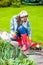 Woman plants flowers in the garden