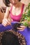 A woman plants a houseplant in a pot.