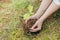 A woman plants a small oak tree in the forest, a volunteer helps to plant new trees, close-up photo