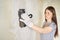 Woman plastering the walls with finishing putty in the room