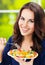 Woman with plate of vegetarian vegetable salad