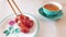 Woman plating Chinese meatballs to delicate porcelain dish