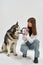 Woman play with circle puller toy with dog