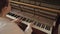 Woman play on open vintage wooden piano