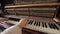 Woman play on open vintage wooden piano