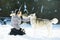 Woman play with siberian husky dog at winter