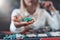 Woman player hold poker chips on the table with card in a casino