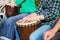 Woman playing on Africa Jambe Drum