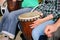 Woman playing on Africa Jambe Drum