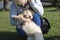 Woman playing with a cockapoo puppy outdoors