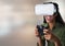 woman playing with computer game controller and Virtual reality headset with bright blurred backgrou