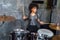 Woman playing drums in musical studio, drummer rock concept