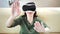 Woman playing in game touching something by hands wearing modern virtual reality glasses