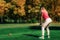 Woman playing golf, getting ready for the shot