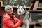 Woman playing with huskie