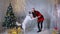 Woman playing with husky dog near christmas tree.
