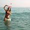 Woman playing paddle ball in the ocean