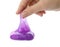 Woman playing with purple slime on white, closeup. Antistress toy