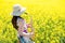 Woman playing saxophone in rapeseed field