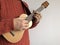 Woman playing soprano ukulele indoors