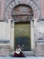 A woman playing a Spanish Flamenco Guitar in front of Mosque Cathedral of Cordoba