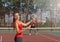 Woman playing tennis and preparing for sports competition.