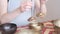 Woman playing on Tibetan singing bowl while sitting on yoga mat. Vintage tonned. stock footage. Slow Motion video. Close