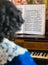 Woman playing vintage piano.