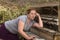 Woman Playing Wooden Piano in Desert, Contemplative Expression