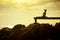 woman playing yoga pose on beach pier against beautiful sun rising sky