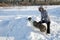 Woman plays with a dog in the winter