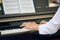 Woman plays electric piano at outdoor music performance, close up view to nimble hands