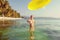 Woman plays frisbee in the water of beautiful ocean