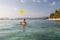 Woman plays frisbee in the water of beautiful ocean